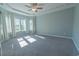 Spacious bedroom bathed in natural light from multiple windows, with plush carpeting at 395 Dunbarton Ln., Conway, SC 29526