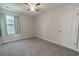 Bedroom with carpet, ceiling fan, window with curtains, and white door at 395 Dunbarton Ln., Conway, SC 29526