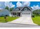 Charming two-story home featuring attached two car garage and well-manicured front yard at 395 Dunbarton Ln., Conway, SC 29526