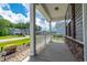 Inviting front porch features stone accents, white railings, and ample space for outdoor seating at 395 Dunbarton Ln., Conway, SC 29526