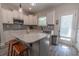 Modern kitchen features an island with bar stools, sleek countertops, and stainless steel appliances at 395 Dunbarton Ln., Conway, SC 29526
