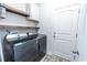 Laundry room with new washer and dryer, wooden shelving, and white door at 395 Dunbarton Ln., Conway, SC 29526