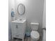 Powder room with wooden framed mirror, white vanity, and gray floors at 395 Dunbarton Ln., Conway, SC 29526