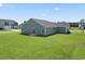 Rear exterior showing a well-maintained lawn and a sliding glass door at 40 Cape Point Dr., Conway, SC 29527