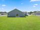 Backyard view showcasing a green lawn, sliding glass door and neighboring homes at 40 Cape Point Dr., Conway, SC 29527