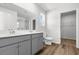 A bright bathroom features double sinks, wood-look floors and a walk-in closet at 40 Cape Point Dr., Conway, SC 29527