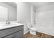 Modern bathroom featuring a stylish vanity, toilet, and a clean bathtub with shower, and vinyl floors at 40 Cape Point Dr., Conway, SC 29527