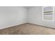 Light-filled bedroom featuring neutral walls, plush carpeting, and a bright window, creating a comfortable space at 40 Cape Point Dr., Conway, SC 29527