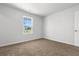 Bright bedroom features cozy carpeting, neutral walls, a window providing natural light, and a door at 40 Cape Point Dr., Conway, SC 29527