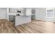 Contemporary kitchen with gray cabinets, stainless steel appliances, granite counters, and wood laminate flooring at 40 Cape Point Dr., Conway, SC 29527