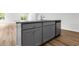 Close up of kitchen island shows granite countertops, stainless dishwasher and gray shaker cabinets at 40 Cape Point Dr., Conway, SC 29527