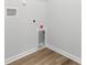 A modern laundry room boasts wood-look flooring and white walls at 40 Cape Point Dr., Conway, SC 29527