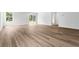Bright living room with laminate floors, sliding glass doors leading to the backyard, and ample natural light at 40 Cape Point Dr., Conway, SC 29527