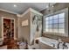 Luxurious bathroom featuring a soaking tub, tiled walls, and elegant fixtures at 4260 Long Avenue Ext., Conway, SC 29526