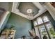 Dining room featuring a decorative ceiling, large windows, chandelier and dark green paint at 4260 Long Avenue Ext., Conway, SC 29526