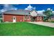 Back exterior view of brick home with a lush, green lawn at 4260 Long Avenue Ext., Conway, SC 29526