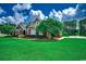Landscaped front yard with a charming brick home and basketball court at 4260 Long Avenue Ext., Conway, SC 29526