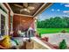 Brick patio showcasing egg chair, covered grill and wooded view at 4260 Long Avenue Ext., Conway, SC 29526