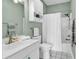 Bathroom with a white vanity, toilet and shower/tub combination with neutral-green walls at 4787 Wild Iris Dr. # 303, Myrtle Beach, SC 29577