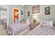 Comfortable bedroom featuring twin beds, a view of a bathroom, complemented by coastal-themed decor at 4787 Wild Iris Dr. # 303, Myrtle Beach, SC 29577