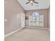 This bedroom has carpet, a ceiling fan, a door to the outside, and a large window with shutters at 4787 Wild Iris Dr. # 303, Myrtle Beach, SC 29577