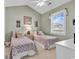 Charming bedroom with two twin beds, complemented by a vaulted ceiling, window and bright coastal decor at 4787 Wild Iris Dr. # 303, Myrtle Beach, SC 29577