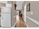 Inviting hallway leads to a living area featuring hardwood floors, neutral tones and a bright, airy ambiance at 4787 Wild Iris Dr. # 303, Myrtle Beach, SC 29577