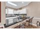 Stylish kitchen featuring dark countertops, white cabinets, and a breakfast bar with seating at 4787 Wild Iris Dr. # 303, Myrtle Beach, SC 29577