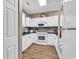 Bright kitchen with white cabinets, dark countertops, stainless appliances, and modern finishes at 4787 Wild Iris Dr. # 303, Myrtle Beach, SC 29577