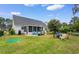Spacious backyard featuring a well-maintained lawn, patio, and outdoor seating, ideal for entertaining or relaxing at 4818 Harvest Dr., Myrtle Beach, SC 29579