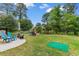 Landscaped backyard with patio, putting green and iron fence bordering the yard's edge at 4818 Harvest Dr., Myrtle Beach, SC 29579