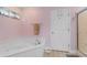 Bright bathroom featuring a large soaking tub, tiled floor, and a convenient shower with glass doors at 4818 Harvest Dr., Myrtle Beach, SC 29579