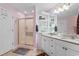 Well-lit bathroom with a double vanity, granite countertop, and a walk-in shower with sliding glass doors at 4818 Harvest Dr., Myrtle Beach, SC 29579