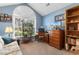 Well-lit bedroom with a large window, desk, chest of drawers, and a comfortable couch creating a cozy, functional space at 4818 Harvest Dr., Myrtle Beach, SC 29579