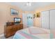 Bedroom featuring a bed with a colorful bedspread, a wooden dresser, and a window offering plenty of natural light at 4818 Harvest Dr., Myrtle Beach, SC 29579