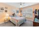Bright bedroom with natural light and a bed that has a colorful quilted bedspread with matching pillows at 4818 Harvest Dr., Myrtle Beach, SC 29579