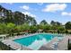 Large community pool with lounge chairs and umbrellas at 4818 Harvest Dr., Myrtle Beach, SC 29579
