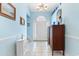 Welcoming foyer with light blue walls, decorative accents, and a clear view of the front door at 4818 Harvest Dr., Myrtle Beach, SC 29579