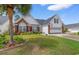 Charming home featuring manicured landscaping, brick accents, a two-car garage and tasteful decorations at 4818 Harvest Dr., Myrtle Beach, SC 29579