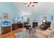 Cozy living room showcasing a fireplace, comfortable seating, and a large TV with a fish tank at 4818 Harvest Dr., Myrtle Beach, SC 29579