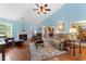 Spacious living room features vaulted ceilings, a fireplace, wood floors, and a plush sofa with cozy armchairs at 4818 Harvest Dr., Myrtle Beach, SC 29579