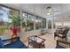 Charming sunroom with wicker furniture, large windows, and a view of the backyard, perfect for relaxation at 4818 Harvest Dr., Myrtle Beach, SC 29579