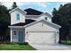 Charming two-story home with white siding, black roof, two-car garage, and landscaping at 4846 Hopespring St., Myrtle Beach, SC 29579