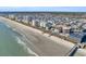 Stunning oceanfront aerial view showcasing community beach access and the local pier at 5806 N Ocean Blvd. # 203, North Myrtle Beach, SC 29582