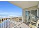 Balcony with seating offers ocean vistas and direct access to the indoors at 5806 N Ocean Blvd. # 203, North Myrtle Beach, SC 29582