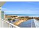 Balcony overlooks ocean with a pier and a community pool at 5806 N Ocean Blvd. # 203, North Myrtle Beach, SC 29582