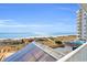 Spacious balcony showcases beautiful beach and ocean views with a glimpse of the pool area at 5806 N Ocean Blvd. # 203, North Myrtle Beach, SC 29582