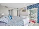 Bright bedroom with balcony access, a wall-mounted TV, and coastal-themed decor at 5806 N Ocean Blvd. # 203, North Myrtle Beach, SC 29582
