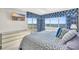 Bedroom with a large window offering serene ocean views, complemented by a mounted TV and coastal decor at 5806 N Ocean Blvd. # 203, North Myrtle Beach, SC 29582