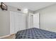Neutral bedroom with carpet, a closet, a wall-mounted television, and an open door at 5806 N Ocean Blvd. # 203, North Myrtle Beach, SC 29582